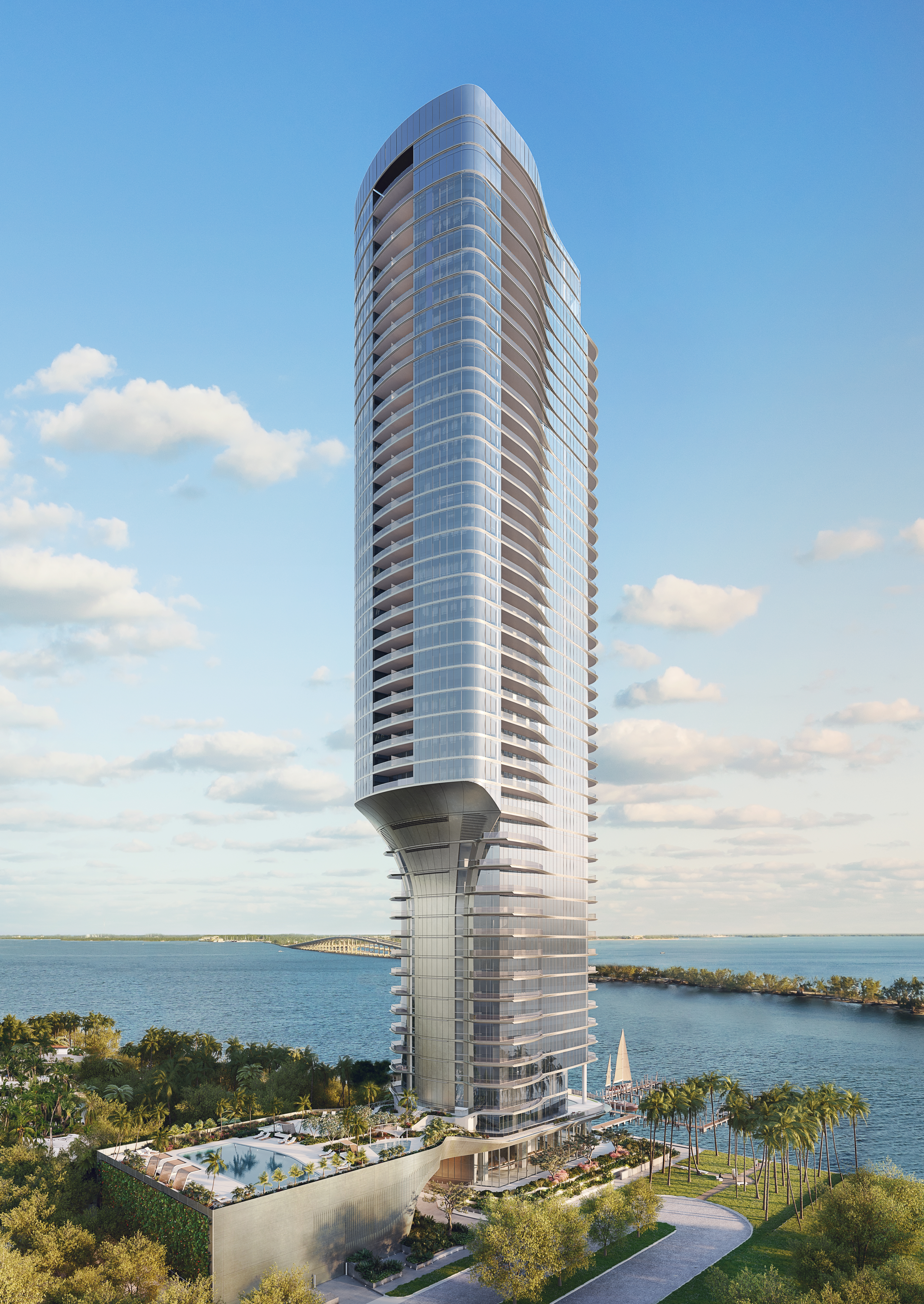 A modern high-rise tower by the water.