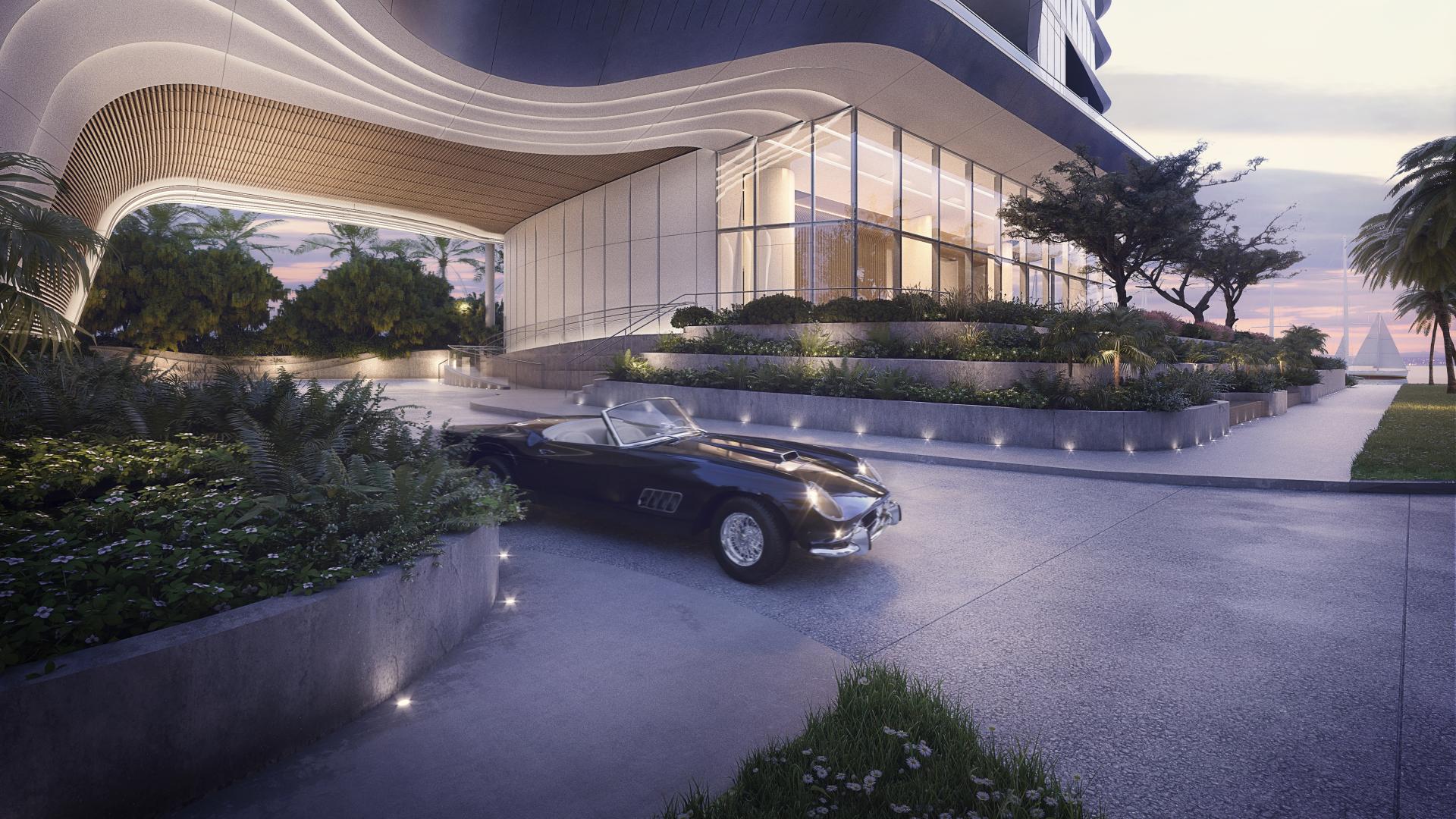 A sleek, modern high-rise entrance with curved architectural details, featuring a classic convertible parked in the driveway.