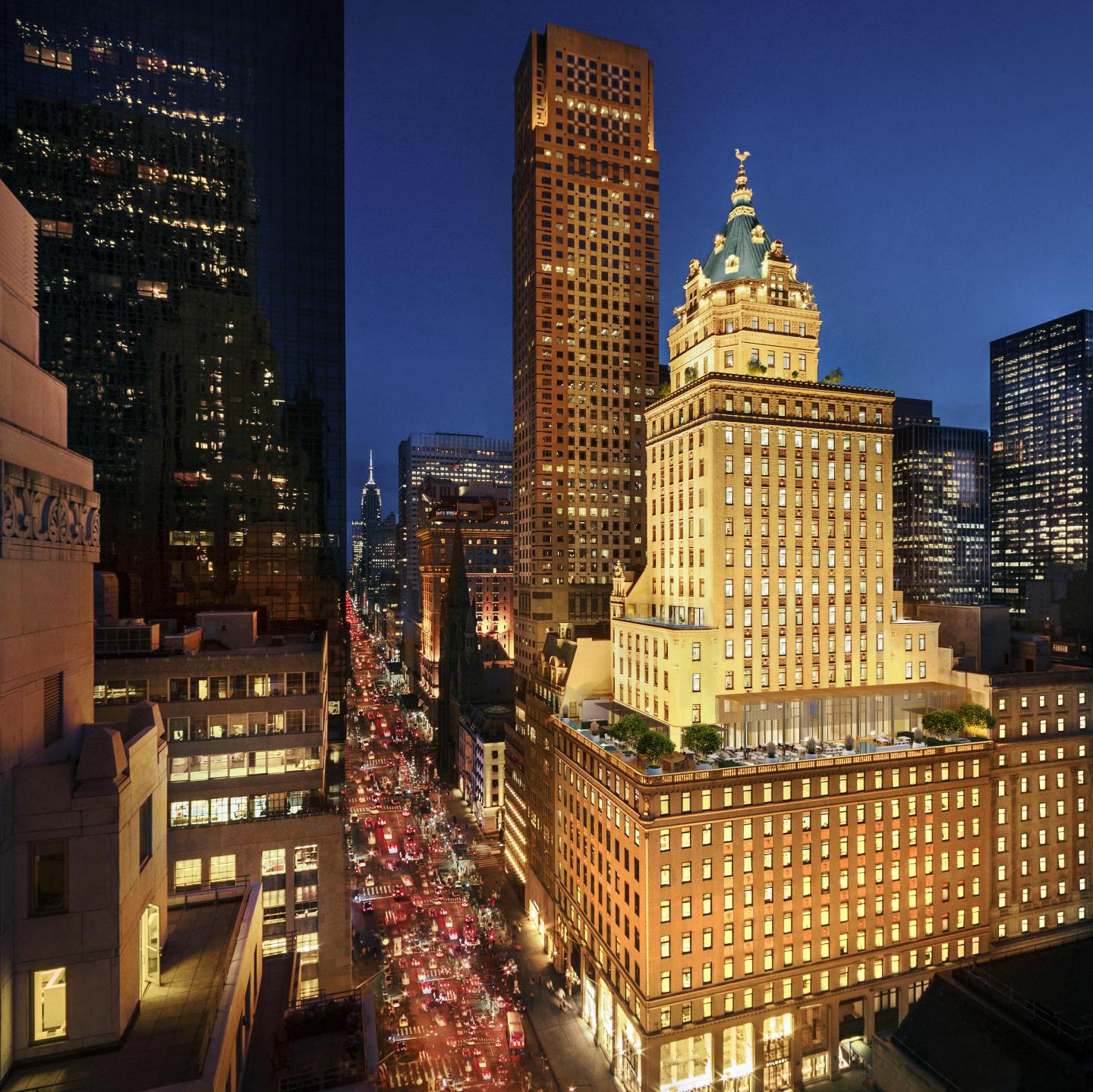 Nighttime cityscape featuring a historic, illuminated building.