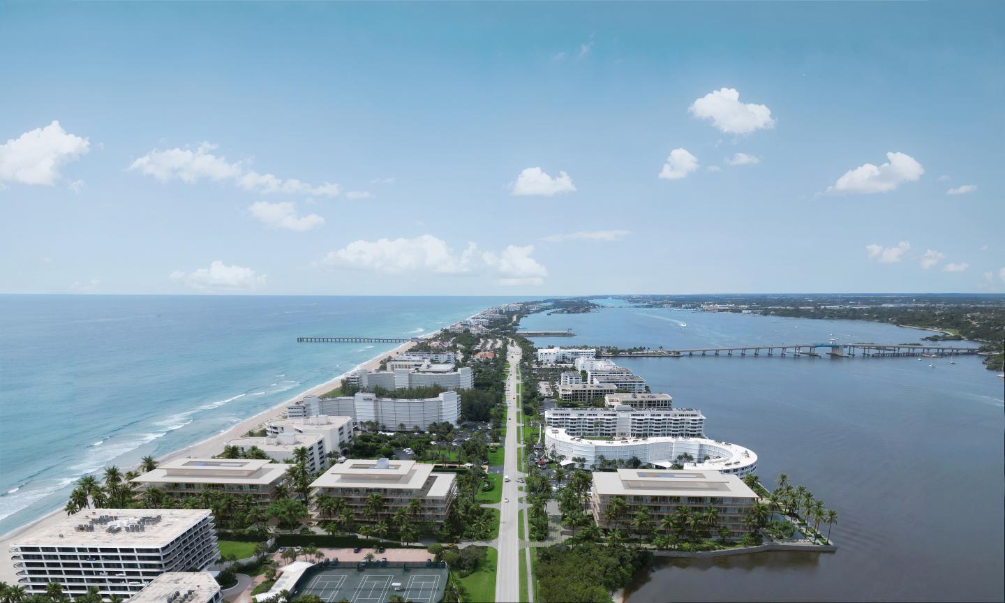 Aerial view of a coastal highway flanked by modern buildings.