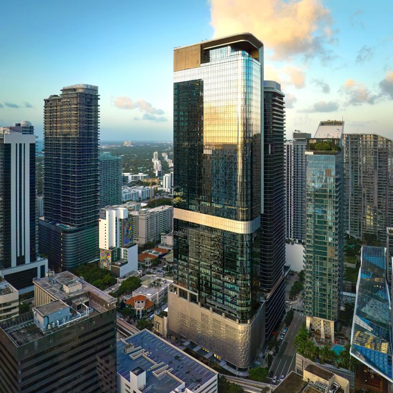  A tall, glass high-rise building reflecting the sunset.